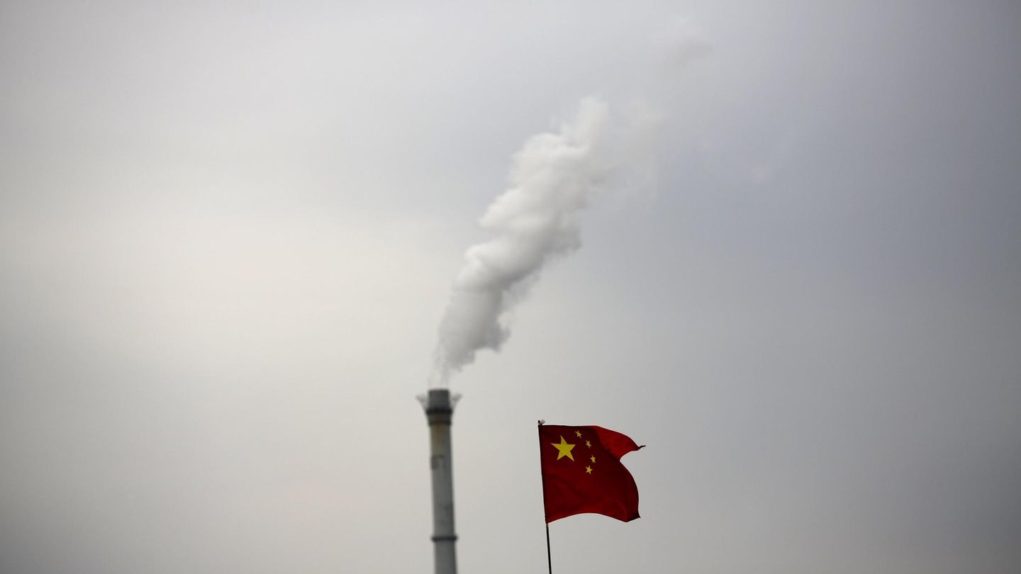 Una bandera china junto a la chimenea de una planta de cogeneración en Pequín. (Reuters)