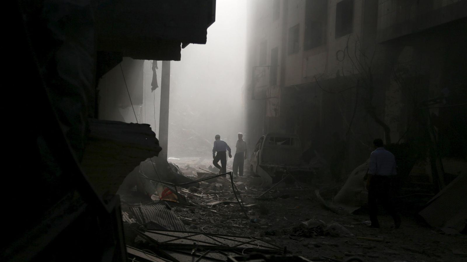 Foto: Civiles sirios inspeccionan un edificio dañado por un bombardeo del régimen en Duma, cerca de Damasco, el 2 de octubre de 2015 (Reuters).