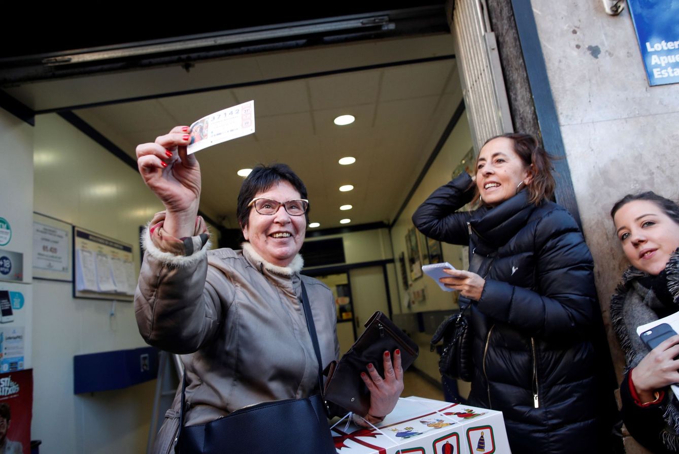 Una mujer enseña su décimo premiado con el 'Gordo' de la Lotería del Niño en Barcelona (EFE)