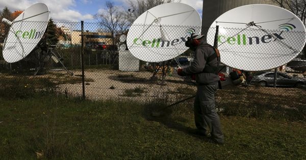 Foto: A worker uses a lawnmower next to telecom antennas of spain's telecoms infrastructures firm cellnex in madrid