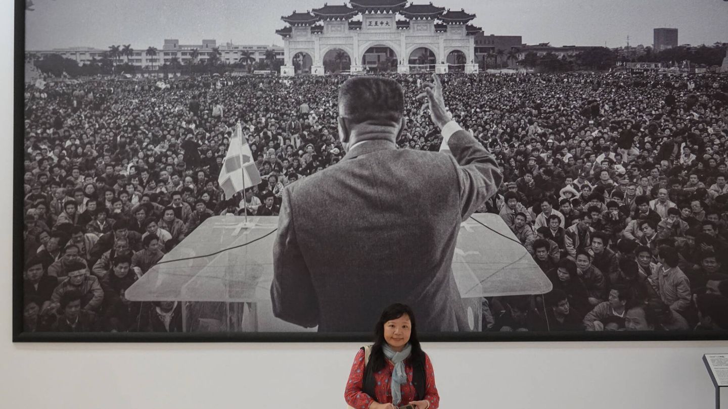 Chung-hua Lin, en el sotano del CKS, frente a la foto de la manifestación por la democracia a la que asistió en 1990. (J. B)