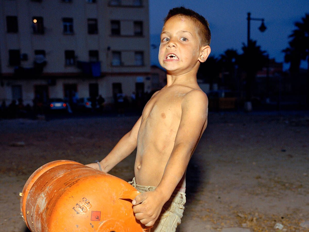 Foto: Un niño del Cabanyal valenciano sostiene una bombona de butano. (Laura Silleras) 