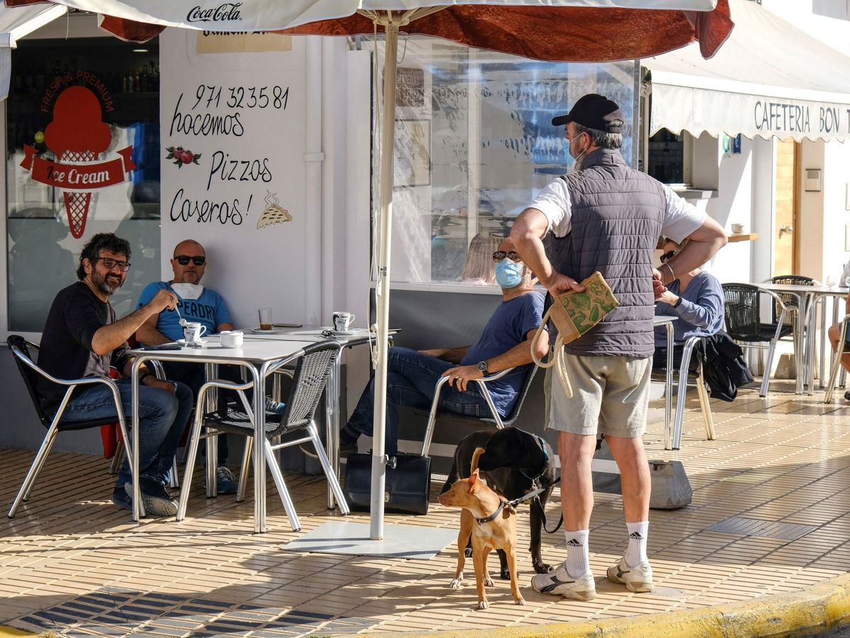 Foto: Un grupo de amigos desayuna juntos en una cafetería abierta en Formentera este lunes. (EFE)