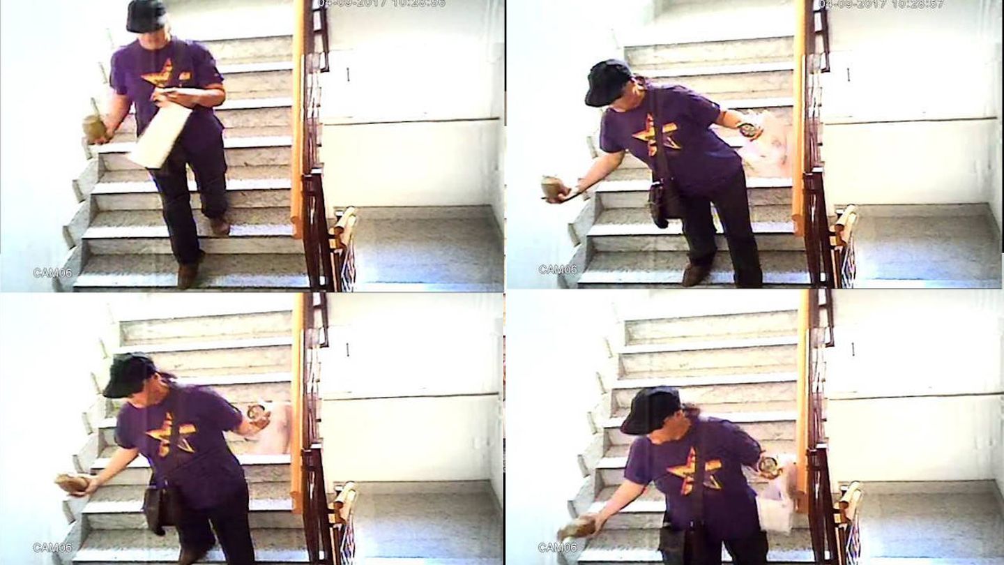 María José vertiendo una sustancia marrón en la escalera del edificio 