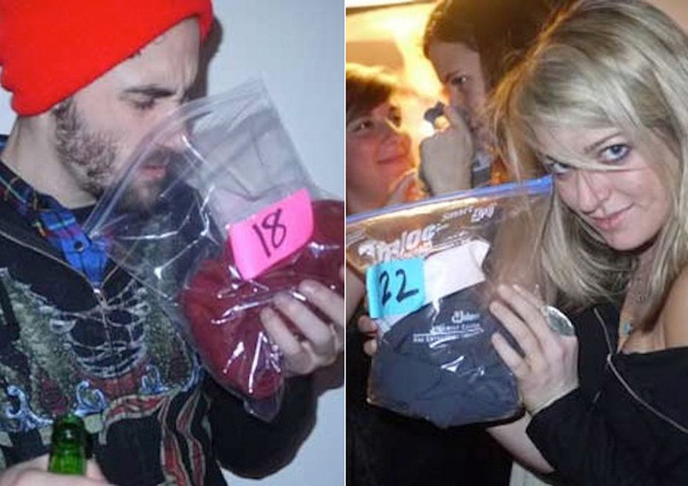Foto: Dos asistentes a una pheromone party olfatean las bolsas con prendas de ropa usada. (pheromoneparties)