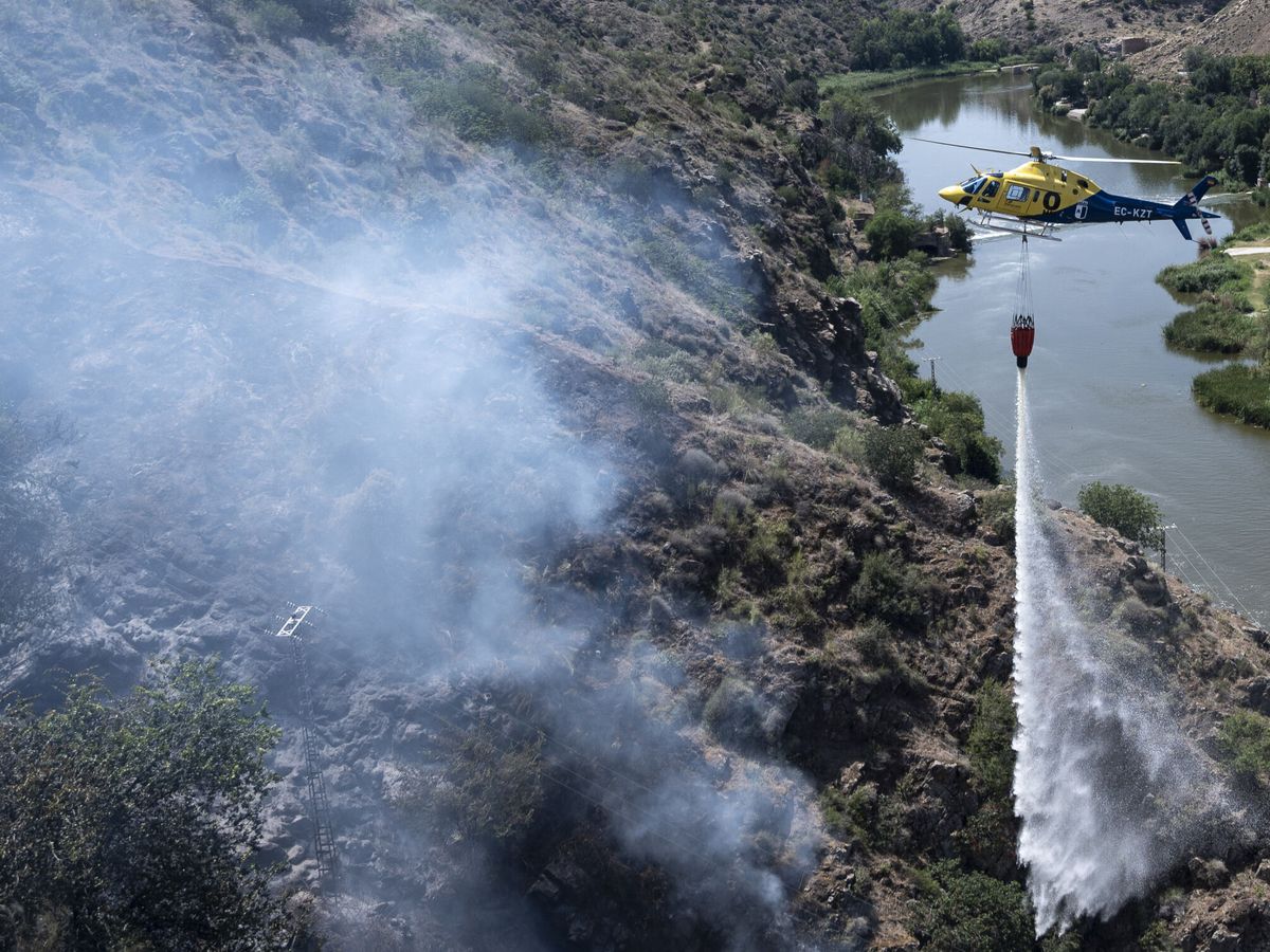 Foto: Una unidad aérea de los bomberos trabajando vía aérea en la extinción del incendio (EFE/Ismael Herrero)