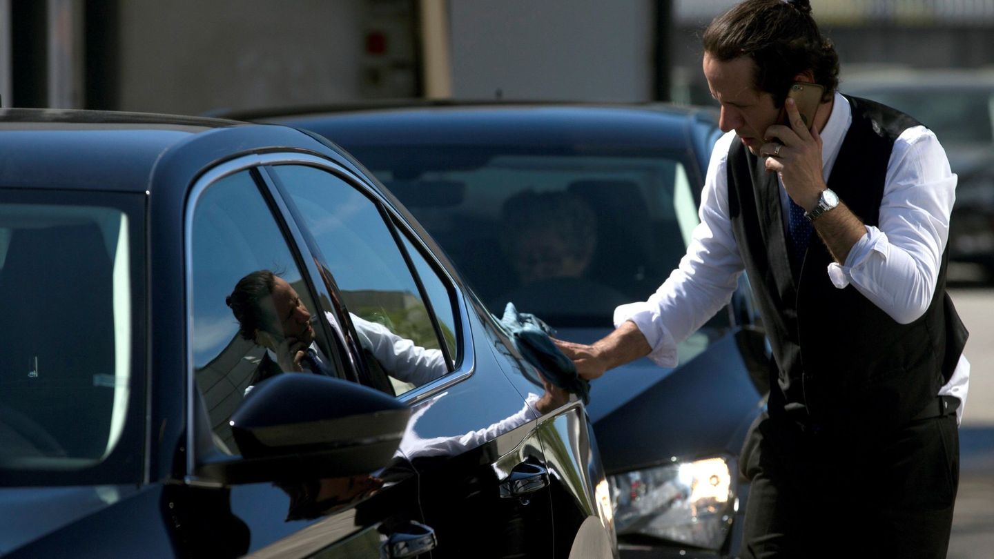 Un conductor de Cabify limpia su vehículo en Barcelona. (EFE)