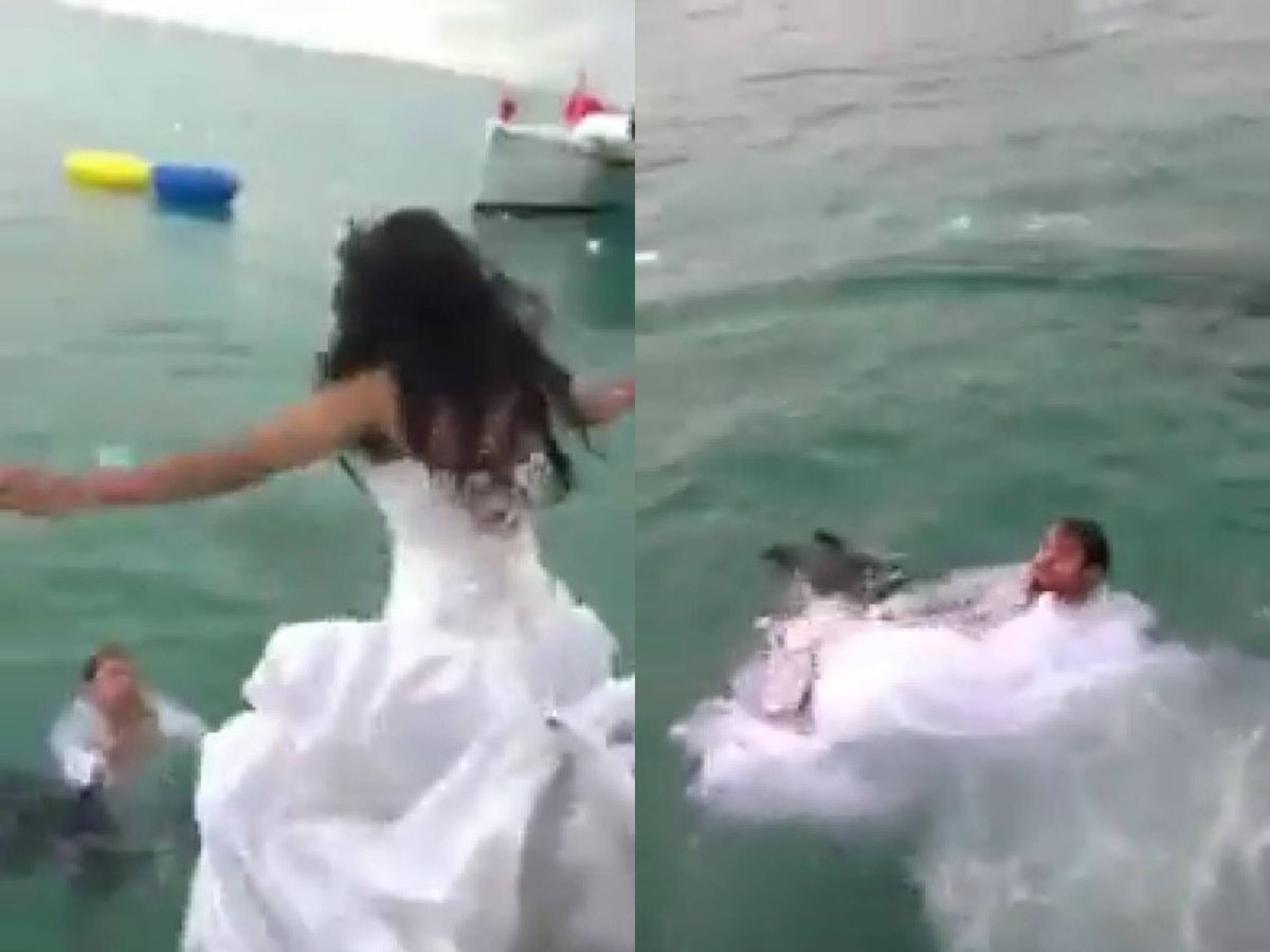 Foto: La novia, con un gran vestido de satén, se lanzó desde una embarcación al mar, donde la esperaba su marido. 
