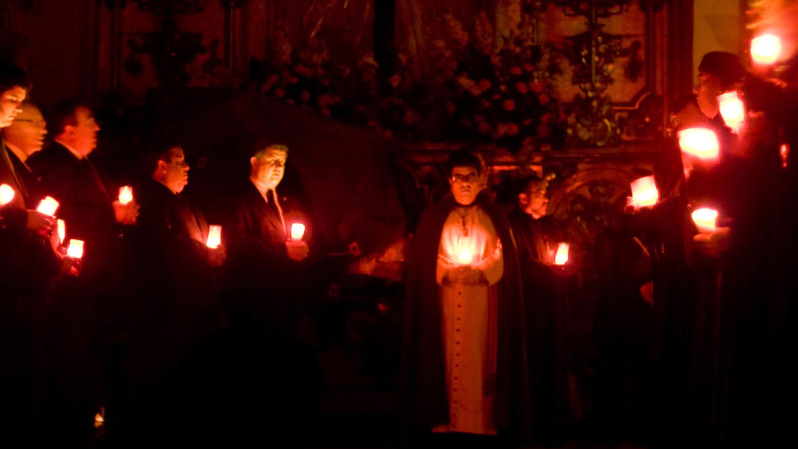 Foto: Los hermanos de la Sangre de Cristo sostienen velas durante una ceremonia en su capilla. (Jorge Sesé)