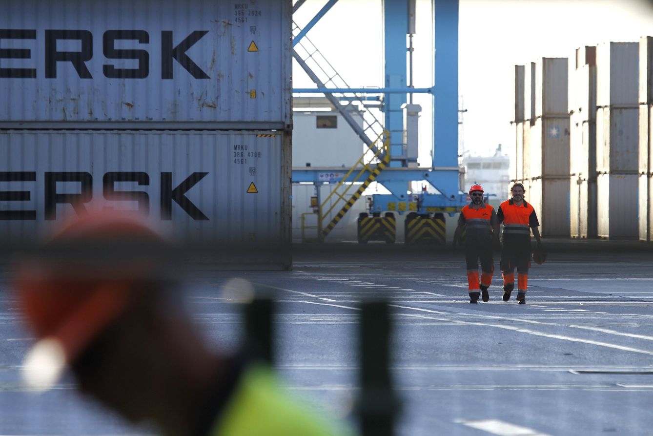 Trabajadores portuarios, junto a contenedores de Maerks en Algeciras. (EFE)