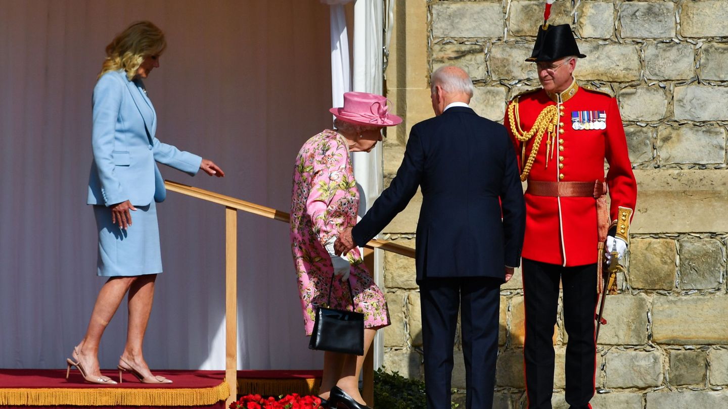 U.S. President Joe Biden stands as first lady Jill Biden and Britain's Queen Elizabeth walk, at Windsor Castle in Windsor, Britain, June 13, 2021. REUTERS Dylan Martinez